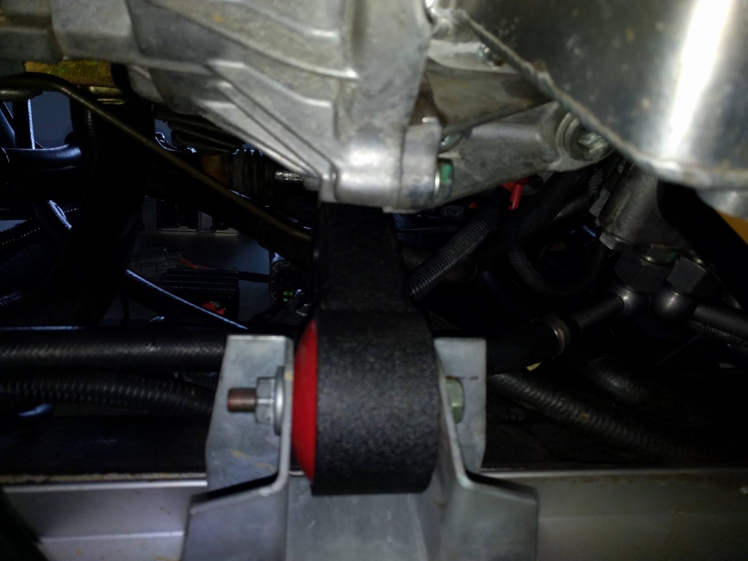 Red 75A urethane engine mount installed in the Lotus